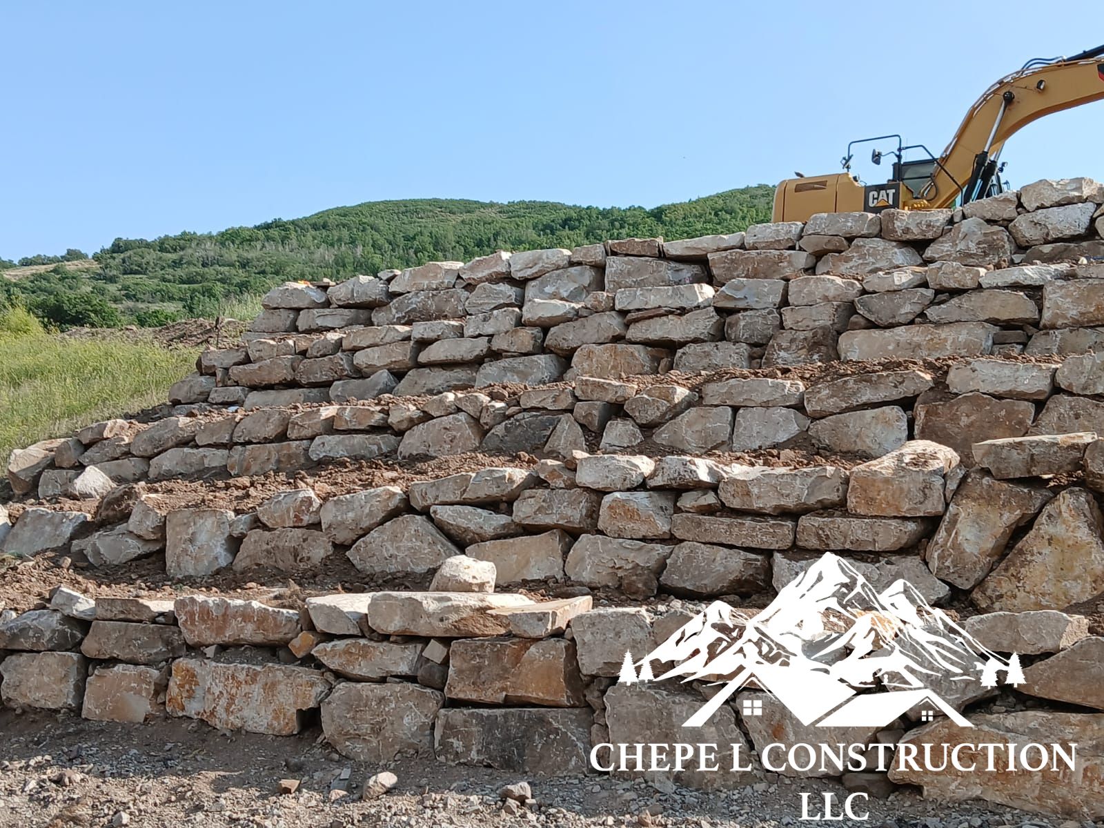 A custom-built rock retaining wall as part of our landscaping services.